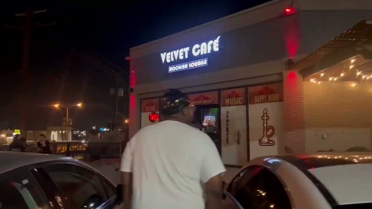 The lit storefront of Velvet Café hookah lounge at night in Dallas