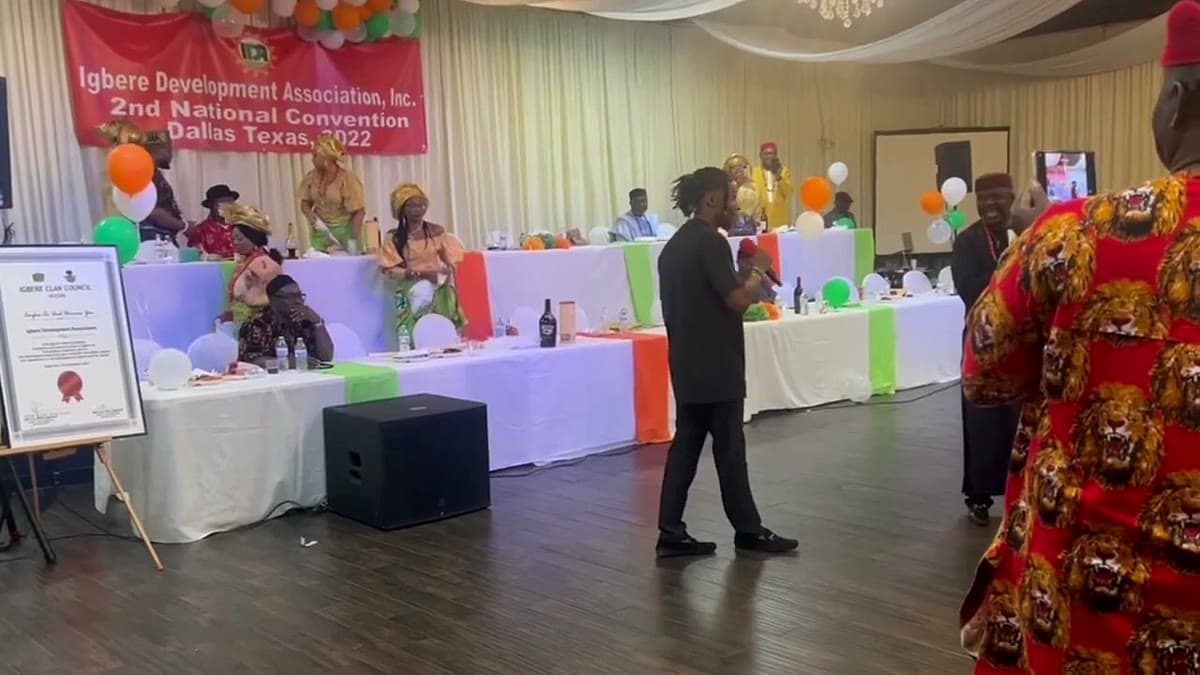 A red banner reading Igbere Development Association 2nd National Convention Dallas Texas 2022 behind a head table of elders in Igbo dress